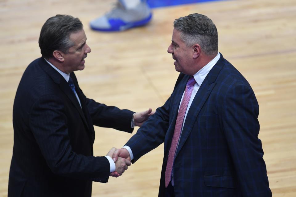 Auburn coach Bruce Pearl, right, said Kentucky coach John Calipari's team still sets the standard in the SEC but other programs have "taken it more seriously."