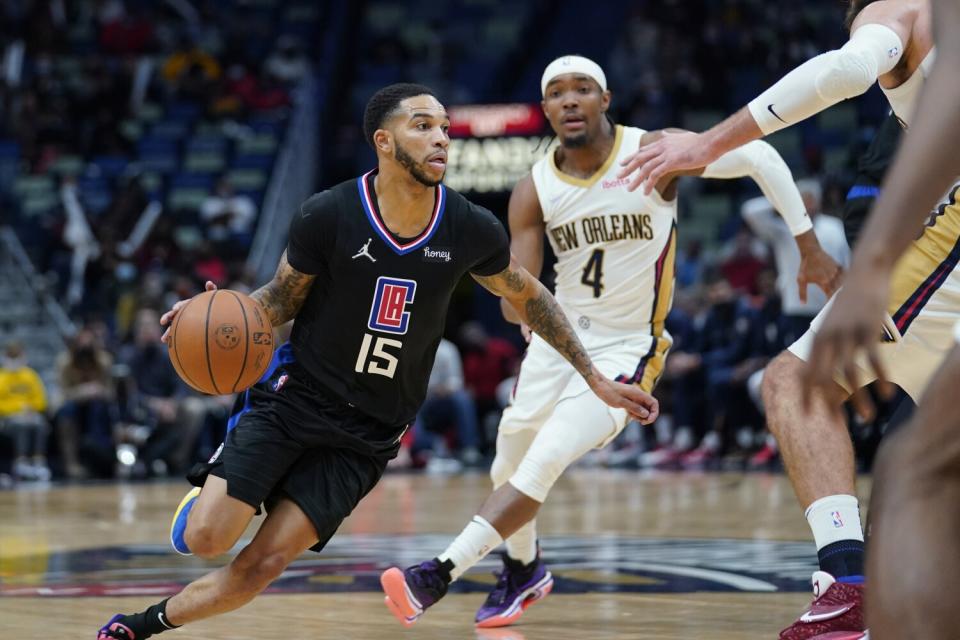 Clippers guard Xavier Moon drives down the lane against the Pelicans.