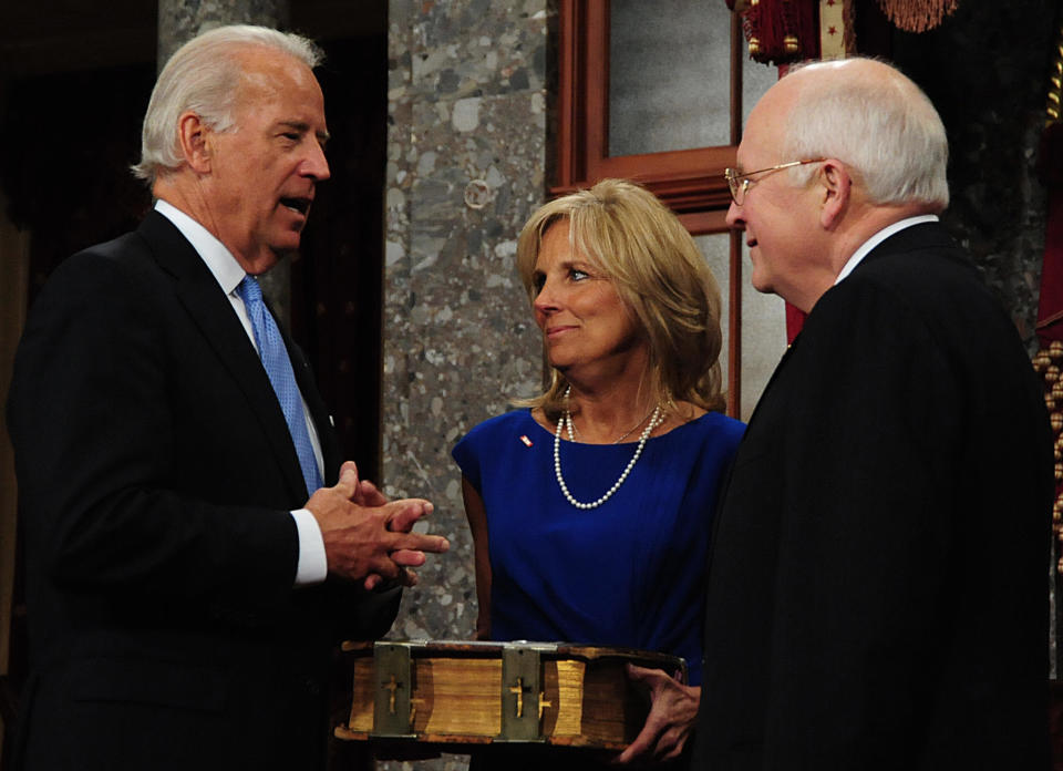 Senator and Vice President-elect Joe Biden speaks to Vice President Dick Cheney as his wife Jill looks on during a swearing in reenactment ceremony at the U.S. Capitol on January 6, 2009 in Washington, DC. (KAREN BLEIER/AFP/Getty Images)