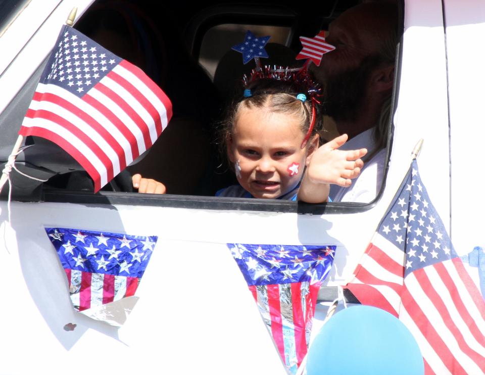 It the thrill of riding in a parade for this little girl.