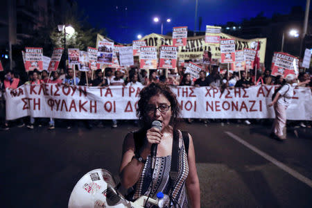 A protester shouts slogans through a loudspeaker during an anti-fascist rally marking four years since the fatal stabbing of Greek rapper Pavlos Fyssas by a supporter of the ultranationalist Golden Dawn party in Athens, Greece, September 16, 2017. REUTERS/Alkis Konstantinidis