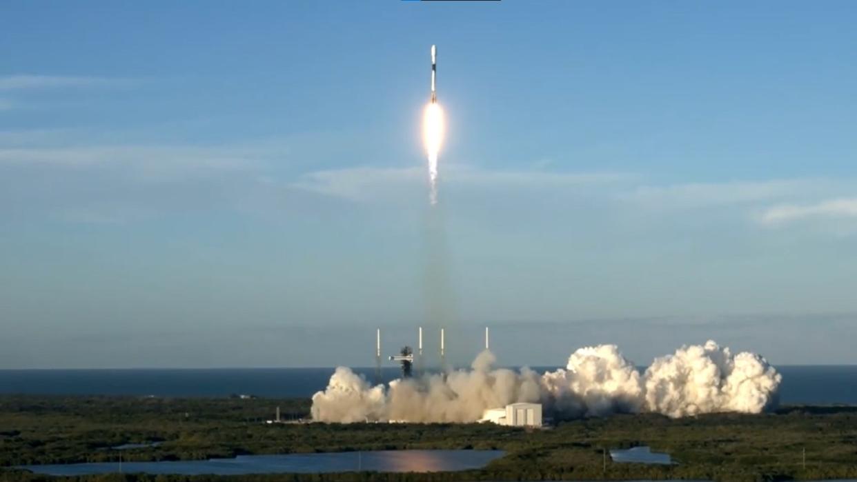  A white rocket flies through the air in a perfectly blue sky. 