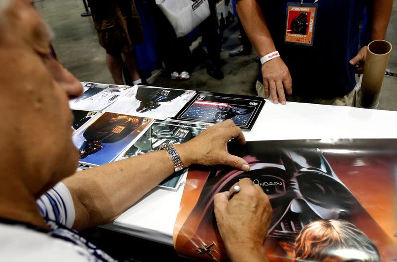 FILE PHOTO: David Prowse, who portrayed Darth Vader, signs autographs during the opening day of Star Wars Celebration IV in Los Angeles