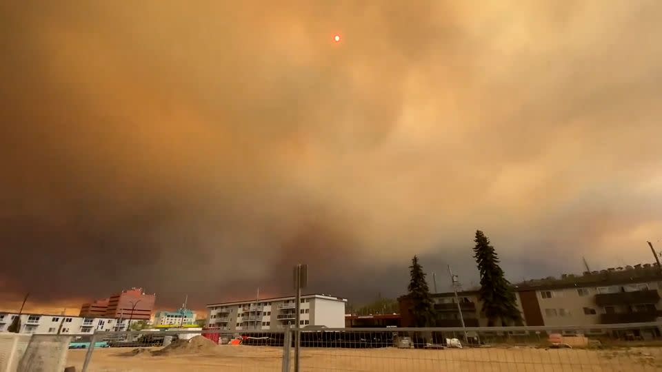 Huge clouds of orange and black smoke fill the sky in downtown Fort McMurray from the wildfires on Tuesday. - Steve Reeve/TMX