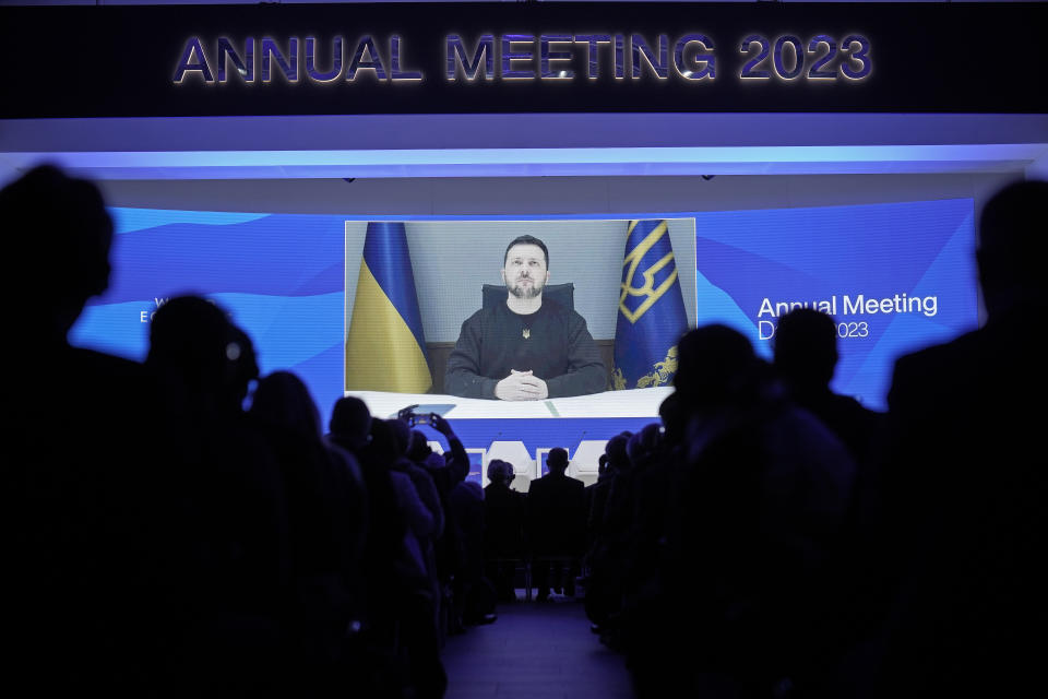 President Volodymyr Zelenskyy of Ukraine talks from a video screen to participants at the World Economic Forum in Davos, Switzerland on Wednesday, Jan. 18, 2023. The annual meeting of the World Economic Forum is taking place in Davos from Jan. 16 until Jan. 20, 2023. (AP Photo/Markus Schreiber)