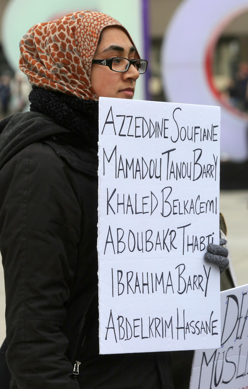 During a rally held in Toronto on Jan. 27, 2018, a woman holds a sign with the names of the six people killed in the Quebec City mosque shooting a year earlier. (Photo: NurPhoto via Getty Images)