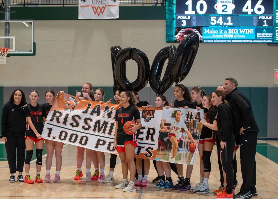 York Suburban's Janay Rissmiller stands with her teammates and coaches after she scored her 1,000th career point in Hoops for Harmony at York County Tech on Sunday, Jan. 14, 2024. The Trojans defeated Obama Academy 64-18.