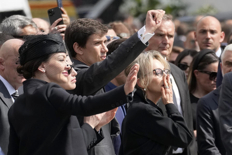 From left, family members of former Italian premier Silvio Berlusconi, from left, daughter Eleonora, daughter Barbara, son Luigi and daughter Marina, wave at the casket of Berlusconi leaving Milan's duomo Gothic-era Cathedral at the end of his state funeral, Italy, Wednesday, June 14, 2023. Berlusconi died at the age of 86 on Monday in a Milan hospital where he was being treated for chronic leukemia. (AP Photo/Antonio Calanni)