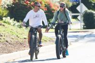 <p>Robin Wright and husband Clement Giraudet show off their multitasking prowess as they hold hands while biking on Saturday in L.A. </p>