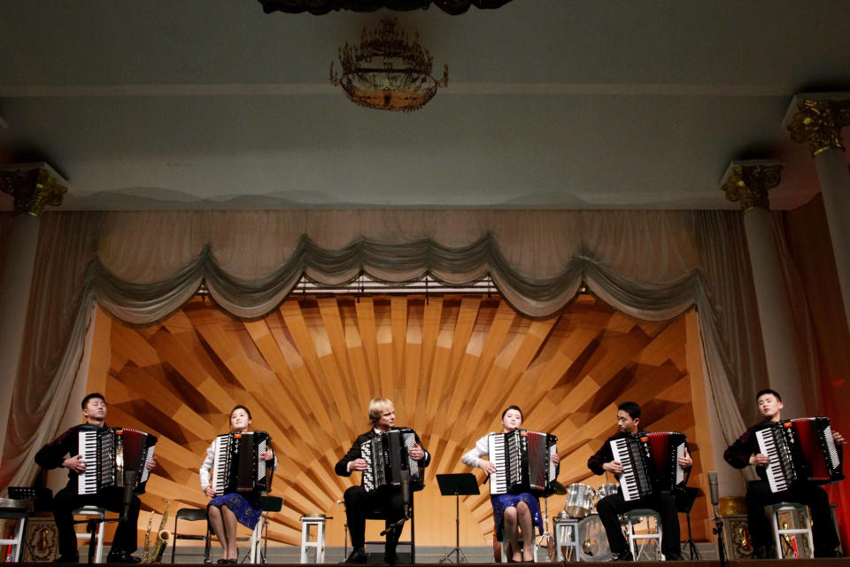 Norwegian musician Frode Haltli plays accordion with music students from North Korea's Kumsong University during a performance in Pyongyang on Thursday May 17, 2012. North Korean students shot to YouTube fame earlier this year with their spirited rendition of "Take on Me." They were joined Thursday by North Korean and Norwegian musicians for a concert in Pyongyang to mark Norway's national day. (AP Photo/Kim Kwang Hyon)