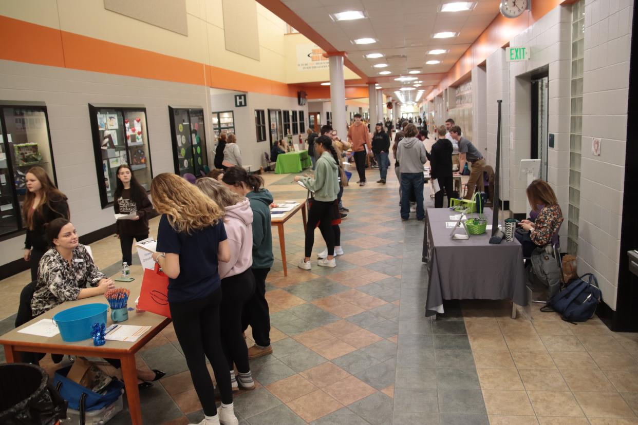 Representatives of more than 30 businesses, government agencies, nonprofit organizations and the military fill the main hallway at Tecumseh High School for the school's Career Exploration Fair Wednesday.