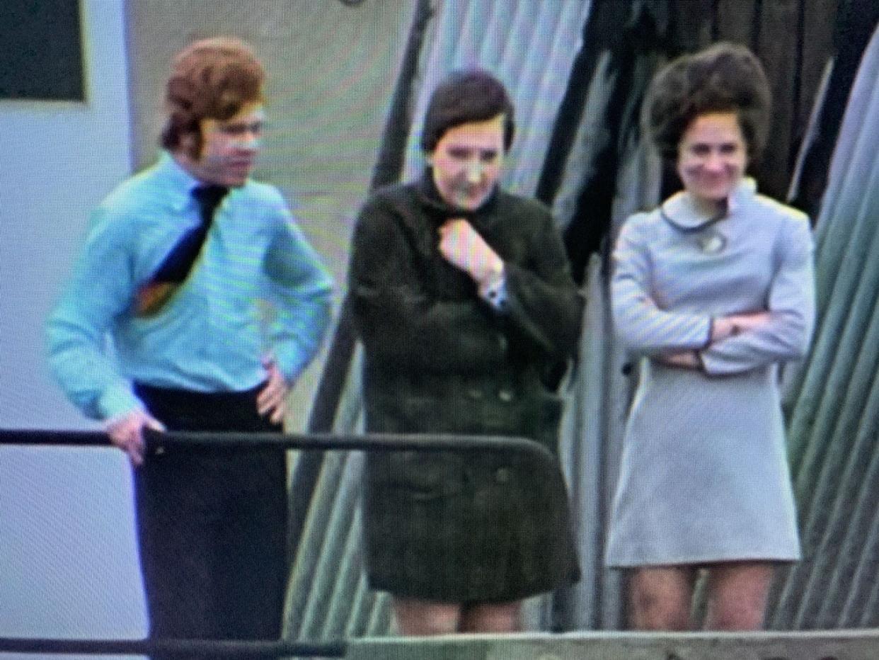 Jennifer "Jenny" Spruill (at right, in dress) watching The Beatles play their final concert together on the rooftop of a London building in 1969.