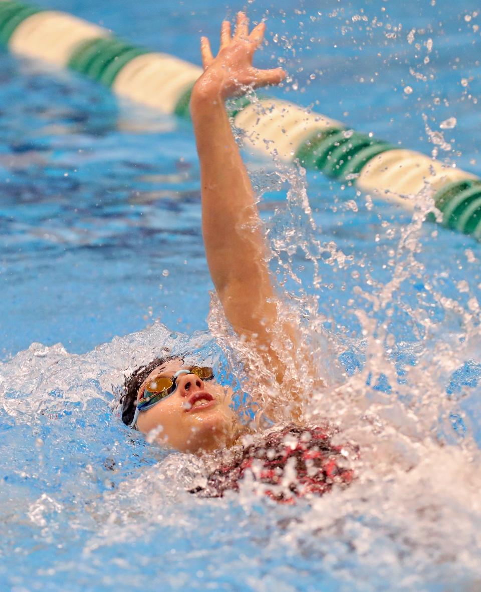 Marlington's Leah Guess competes in the girls 100 backstroke event during the Division II District Swimming and Diving Championships on Friday.