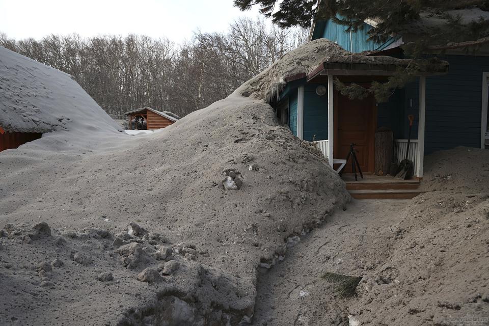 In this photo provided by the Russian Academy of Sciences' Volcanology Institute, volcanic ash covers the ground and houses after the Shiveluch volcano's eruption in Klyuchi village on the Kamchatka Peninsula in Russia, Tuesday, April 11, 2023. The volcano has erupted on Russia's far eastern Kamchatka Peninsula. The eruption early Tuesday of Shiveluch, one of Kamchatka's most active volcanoes, spewed clouds of dust 12 miles into the sky. (Yury Demyanchuk/Russian Academy of Sciences' Volcanology Institute via AP)