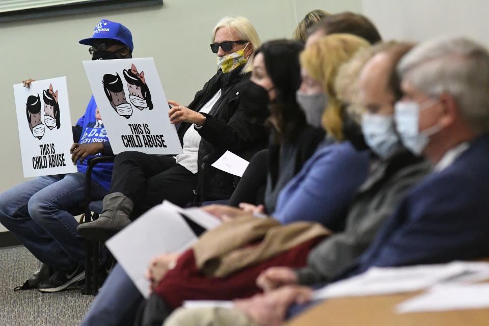 People in attendance at a February 2022 school board meeting protest the district's mask mandate. The new organization Moms for Liberty wants to focus on bringing back parental rights, such as choosing whether their children wear masks. STARNEWS FILE PHOTO