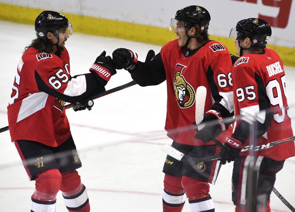 The fiancee of Ottawa Senators’ Mike Hoffman (68) is accused of harassing the wife of Erik Karlsson (center). (Justin Tang/The Canadian Press via AP)