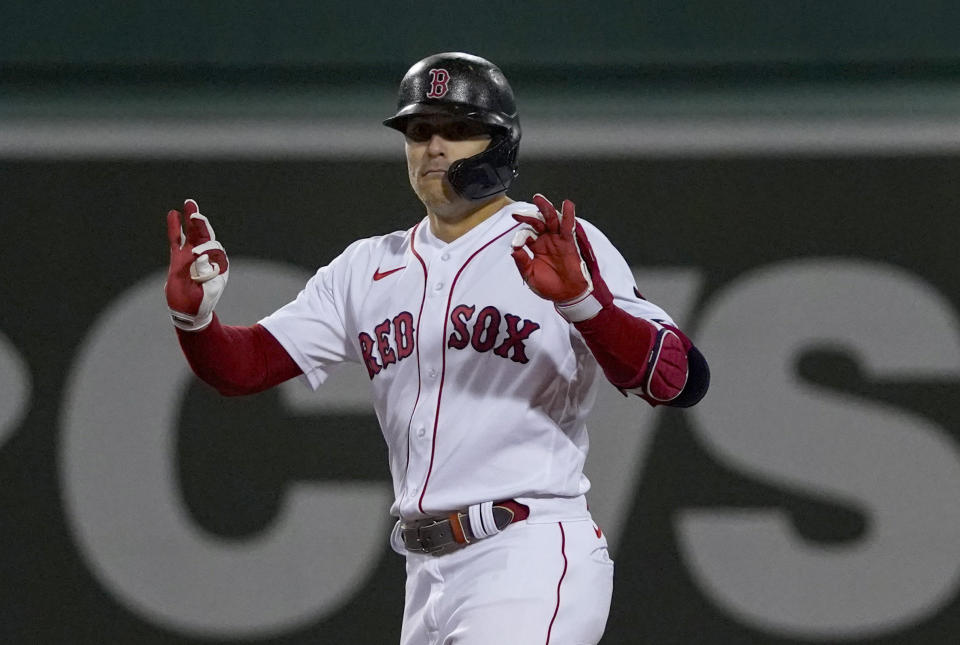 Boston Red Sox's Enrique Hernandez gestures to the dugout after hitting an RBI-double, scoring Alex Verdugo, during the sixth inning of a baseball game against the Tampa Bay Rays at Fenway Park, Monday, Oct. 3, 2022, in Boston. (AP Photo/Mary Schwalm)