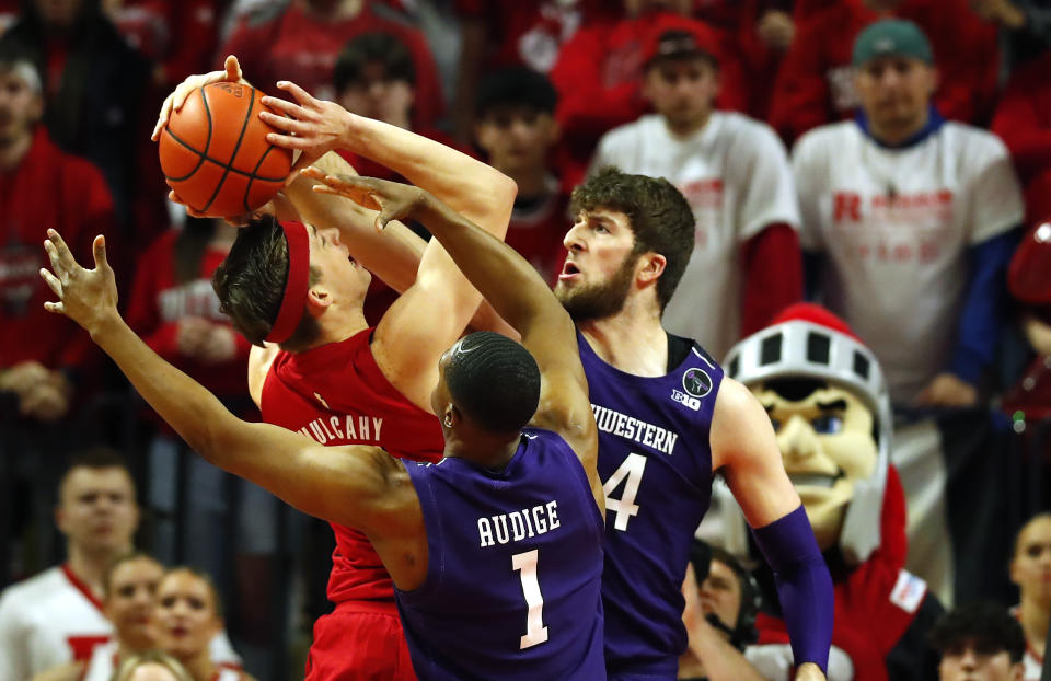 Northwestern center Matthew Nicholson and Northwestern guard Chase Audige (1) defends against Rutgers guard Paul Mulcahy (4) during the first half of an NCAA college basketball game, Sunday, Mar.5, 2023, in Piscataway, N.J. (AP Photo/Noah K. Murray)