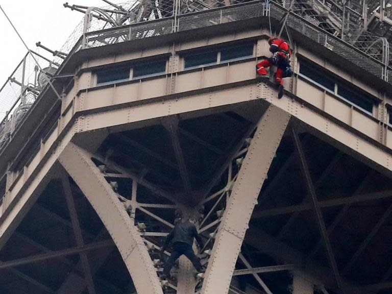 The Eiffel Tower has been evacuated after a man attempted to climb to the top of the famous Parisienne monument.His motives for scaling the landmark are not immediately clear and rescue efforts are still ongoing.The man could be seen dangling just below the third and highest level of the structure on Monday evening, or around 300m into the air. It was not immediately clear how he managed to get past the iconic monument's stringent security system. A Paris police spokeswoman said a team of firefighters including a climbing specialist was on the scene and in touch with the intruder, whose motivations remain unclear. They did not provide further information about the incident or the man's name. The tower, the tallest structure in Paris, is 324 metres high, about the same height as an 81-story building.It’s not the first time someone has attempted to climb up the tourist attraction.In 2015, British freerunner James Kingston climbed the edifice without safety ropes and without permission, dodging security cameras as he went. > En photo, l’homme qui grimpe la tour eiffel en France. Les sapeurs-pompiers essayent de le sauver sans résultat pour le moment. pic.twitter.com/jSXl8AYsXB> > — mellouk abdelaziz (@MAbdmellouk) > > 20 May 2019> Quand t’en as marre et tu veux squatter la Tour Eiffel à toi tout seul🧐 LaTourEiffel Paris pic.twitter.com/ibUpf2QxYm> > — Salah_Dine_Al_Ayyoubi (@ayyoubi_salah) > > 20 May 2019In 2017 the monument was closed down after a man climbed over safety railings and threatened to jump off.In 1996, French climber Alain Robert, who known but his "Spiderman" nickname, took just 45 minutes to scale the structure. Additional reporting from agencies