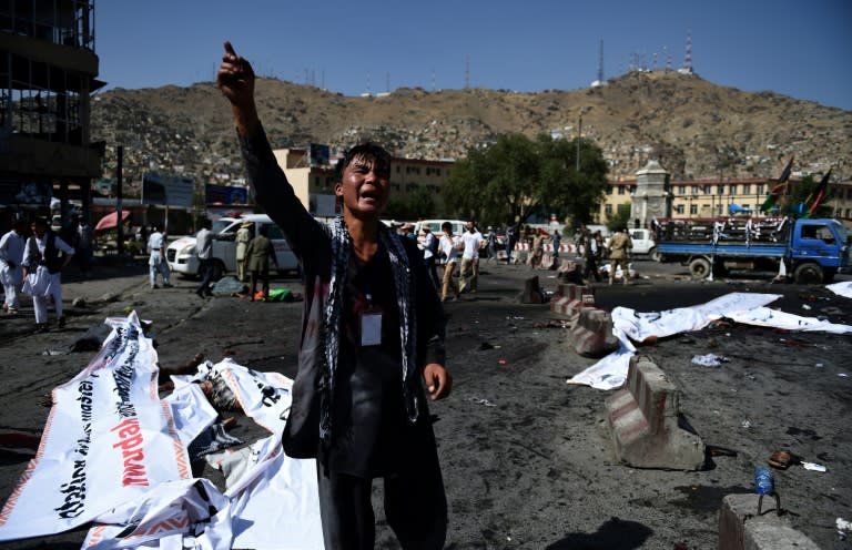 A protester screams near the scene of a suicide attack that targeted crowds of minority Shiite Hazaras during a demonstration at the Deh Mazang Circle in Kabul on July 23, 2016