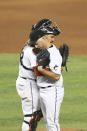 Miami Marlins catcher Jorge Alfaro and pitcher Brandon Kintzler celebrate after the team's baseball game against the Washington Nationals, Sunday, Sept. 20, 2020, in Miami. (AP Photo/Gaston De Cardenas)