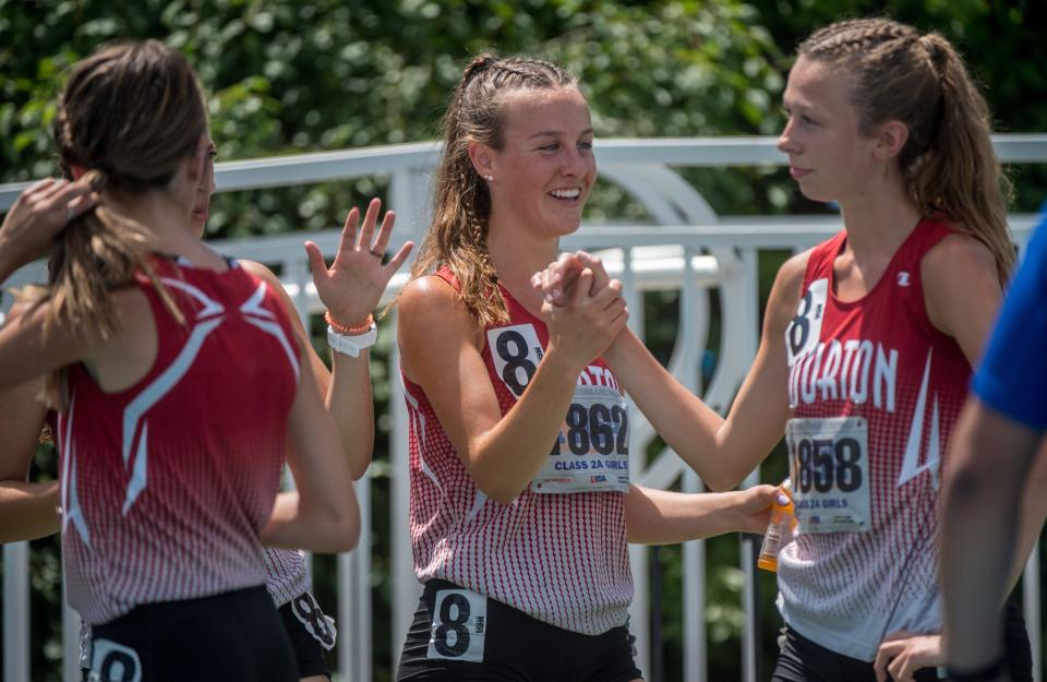 Morton’s Emma Skinner, middle, congratulates her 4X800-meter relay teammate Taygen Beyer after their race Friday, June 11, 2021 during the IHSA Class 2A Girls State Track and Field Championships in Charleston. Morton finished fifth.