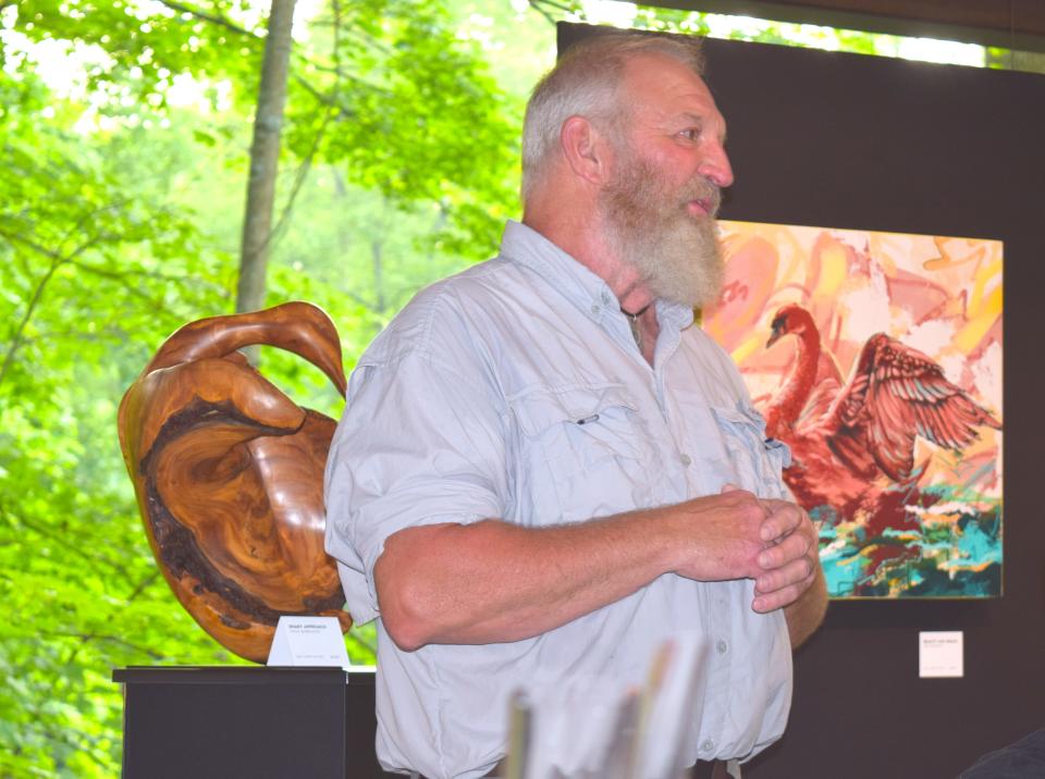 Artist Steve Burelison talks wth visitors to the interactive art experience recently at Inn at Honey Run.