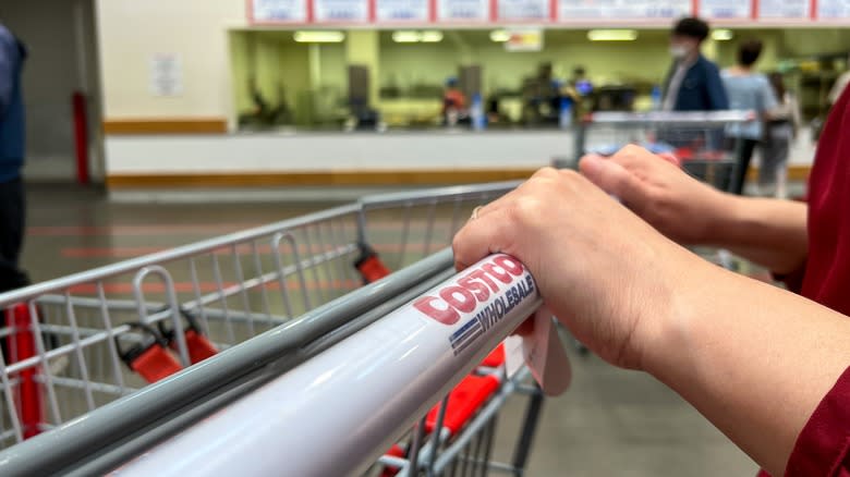 pushing Costco shopping cart