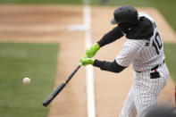 Chicago White Sox's Yoan Moncada singles off Atlanta Braves starting pitcher Charlie Morton during the first inning of a baseball game Monday, April 1, 2024, in Chicago. (AP Photo/Charles Rex Arbogast)