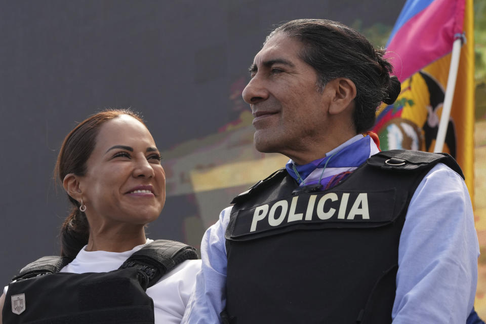 Wearing bulletproof vests, presidential candidate Yaku Perez, right, and his running-mate Nory Pinela, of "Alianza Claro Que Se Puede," or Of Course We Can Alliance, stand before supporters at a campaign rally less than two weeks after a candidate was assassinated, in Quito, Ecuador, Thursday, Aug. 17, 2023. The upcoming snap election set for Aug. 20 was called after President Guillermo Lasso dissolved the National Assembly by decree in May, to avoid being impeached. (AP Photo/Dolores Ochoa)