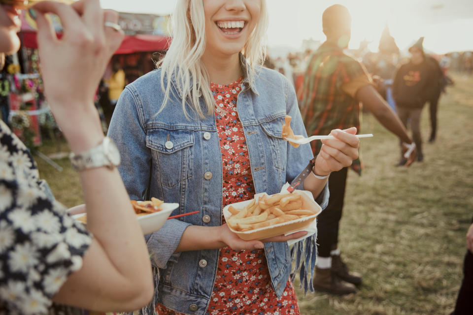 Two women eating at a festival. (Getty Images)