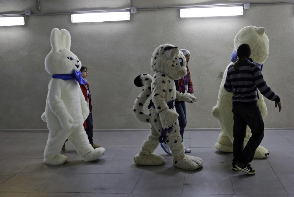Mascots of the 2014 Winter Olympics walk out to the stadium prior to the start of the men's 500-meter speedskating race at the Adler Arena Skating Center in Sochi, Russia, Monday, Feb. 10, 2014. (AP Photo/Matt Dunham)