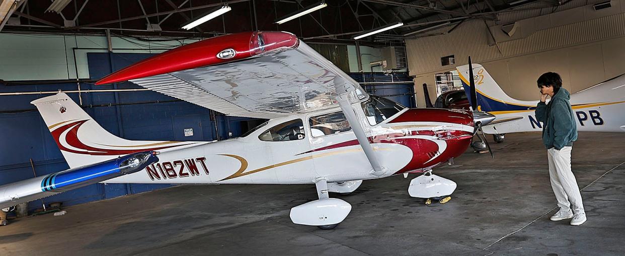 Ethan Guo, 18 of Milton is preparing to fly solo around the world. He has over 600 hours flying planes like his Cessna 182 at Norwood Airport on Friday April 26, 2024