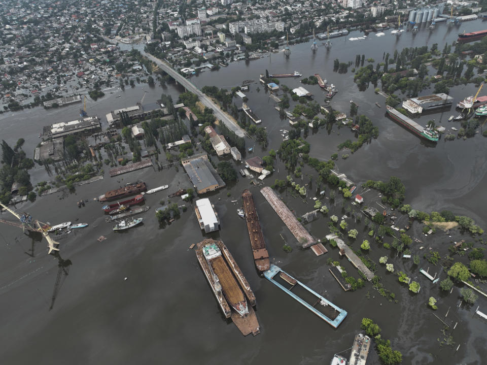 Streets and trade port are seen underwater and polluted by oil in the flooded Kherson, Ukraine, Saturday, June 10, 2023. The destruction of the Kakhovka Dam in southern Ukraine is swiftly evolving into long-term environmental catastrophe. It affects drinking water, food supplies and ecosystems reaching into the Black Sea. (AP Photo)