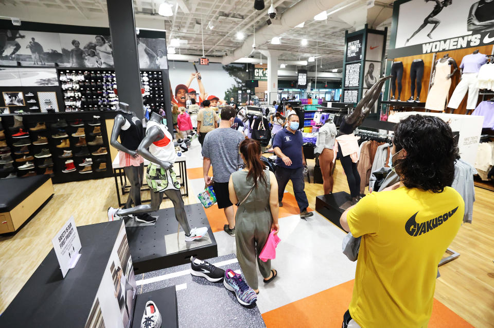 Customers wait in line to pay for items at a Dick's Sporting Goods store.