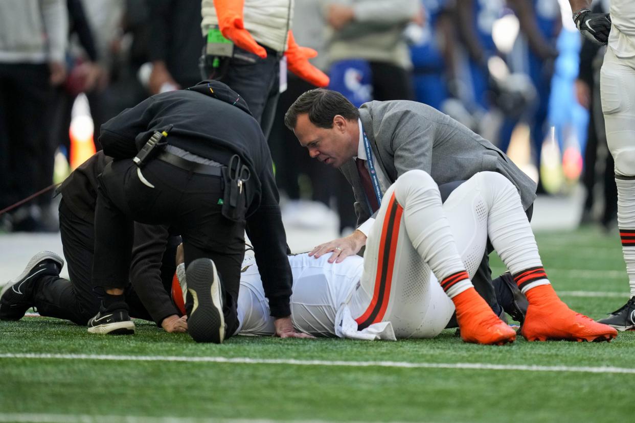 Staff attend to Browns quarterback Deshaun Watson, Sunday, Oct. 22, 2023, in Indianapolis.