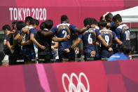 Japan players huddle up after winning their men's rugby sevens 11-12 placing match against South Korea at the 2020 Summer Olympics, Wednesday, July 28, 2021 in Tokyo, Japan. (AP Photo/Shuji Kajiyama)