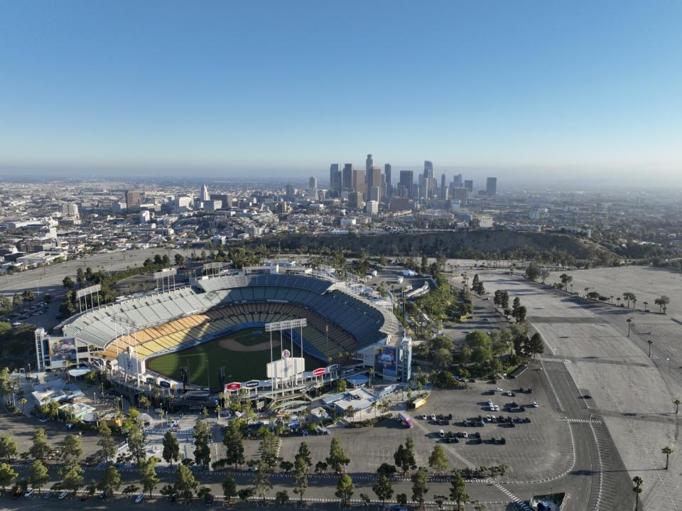 An aerial view of Dodger Stadium, with downtown Los Angeles in the background.