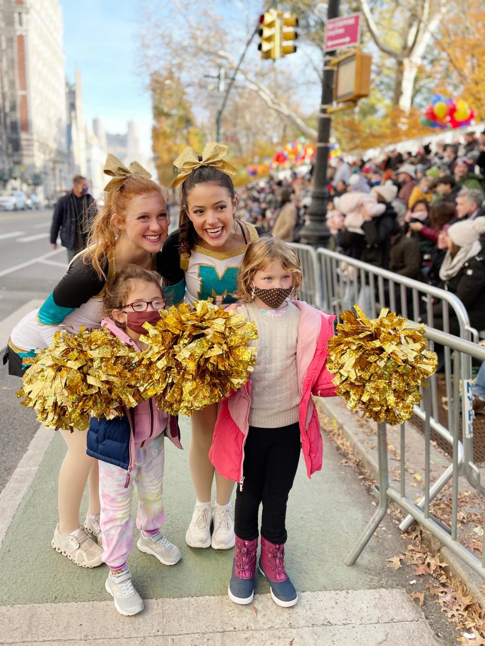 Josie Castle, left, and Gracie Cantrell pose with young spectators at the Macy’s Thanksgiving Day parade. The girls were part of a group of five from Washington, Okla. that traveled to New York City to participate.