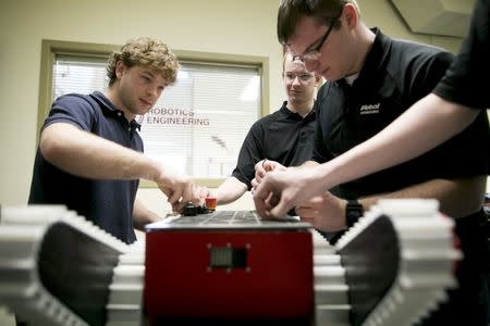 Undergraduate seniors in Prof. Michael Gennert's lab replace the top cover of their amphibious robot "Walrus" at Worcester Polytechnic Institute in Worcester, Massachusetts, March 20, 2015. REUTERS/Dominick Reuter