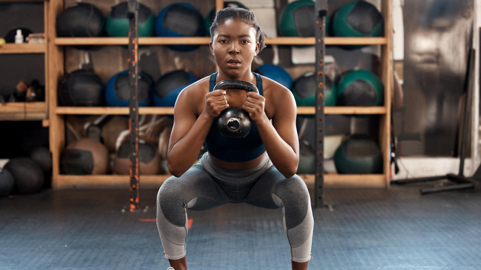 Woman doing goblet squats in gym