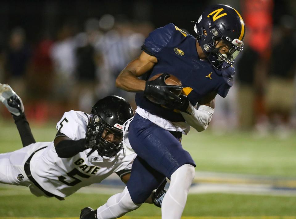 Naples Golden Eagles receiver Damarion Salters (11) runs for a touchdown after making a catch as Golden Gate Titans defensive back Jermaine Fabien (5) dives for him during the third quarter of a district game at Staver Field in Naples on Thursday, Sept. 14, 2023.