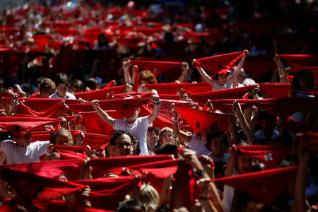 Sergio Colas (C), his daughter Alaia and wife Alma take part in the traditional "Chupinazo" rocket launch during the start of the San Fermin festival in Pamplona, northern Spain, July 6, 2016. REUTERS/Susana Vera