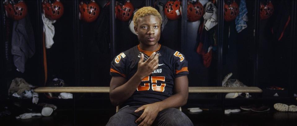 Amaree McKenstry-Hall gives in an interview in a football locker room