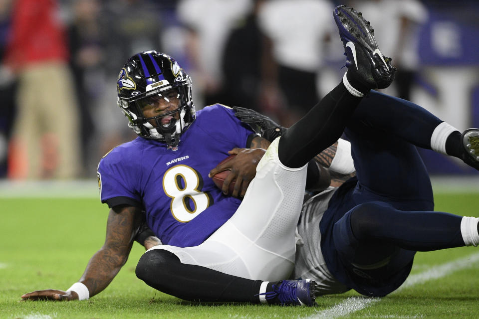 Baltimore Ravens quarterback Lamar Jackson (8) is sacked by Tennessee Titans outside linebacker Kamalei Correa (44) during the first half an NFL divisional playoff football game, Saturday, Jan. 11, 2020, in Baltimore. (AP Photo/Nick Wass)