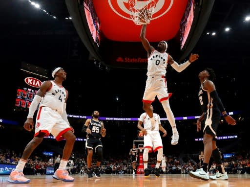 Toronto's Terence Davis dunks against Atlanta's Cam Reddish in the Raptors' NBA victory over the Hawks