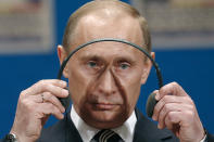 FILE - Russian President Vladimir Putin dons his headphones during a press conference on the third day of the NATO Summit conference in Bucharest, Friday April 4 2008. NATO returns on Tuesday, Nov. 29, 2022 to the scene of one of its most controversial decisions and where it intends to repeat its vow that Ukraine, now suffering through the tenth month of a war against Russia, will be able to join the world's biggest military alliance one day.(AP Photo/Vadim Ghirda, File)