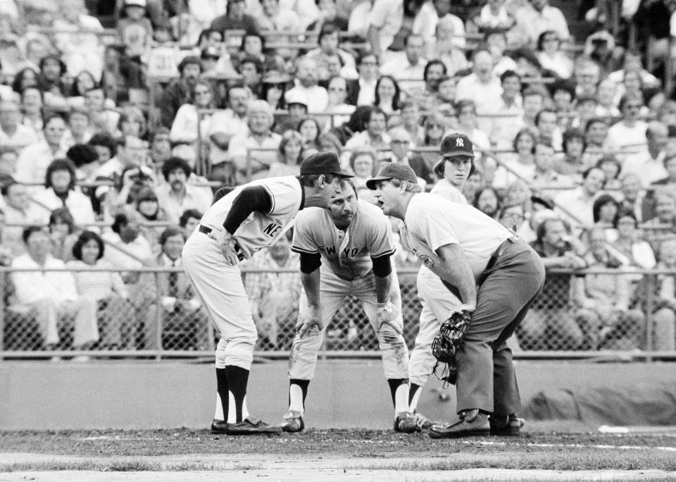 Thurman Munson, center, listen as Yankees manager Billy Martin argues with umpire Edwin Merrill after Merrill called Munson out on a steal attempt at home against the Twins in Bloomington, Minn., July 20, 1978.