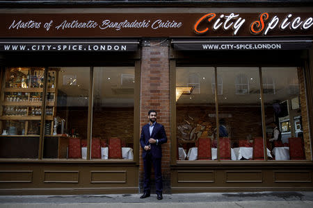 Abdul Ahad, the son of the owner of the City Spice curry house, poses for a photograph outside his restaurant on Brick Lane in London, Britain January 7, 2019. Picture taken January 7, 2019. REUTERS/Simon Dawson