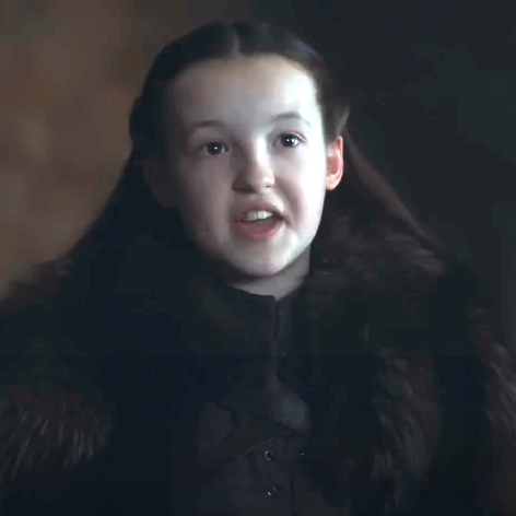 Bella Ramsey as Lyanna Mormont in Game of Thrones, wearing a dark fur-trimmed costume